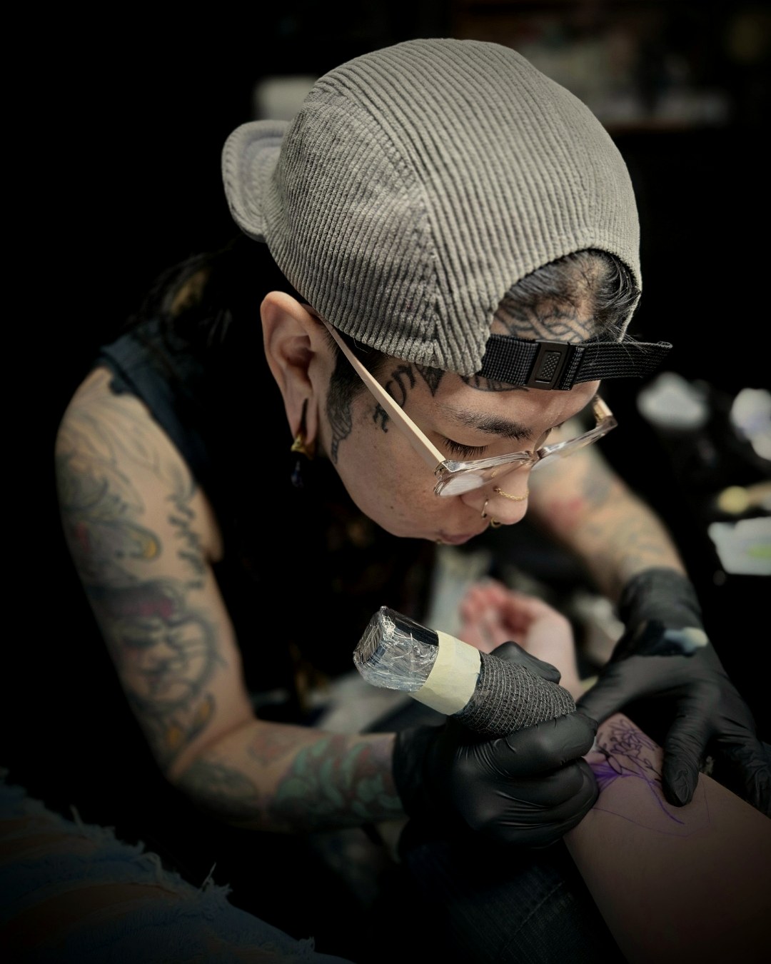 Final Touch Tattoo artist Yvonne working on a detailed tattoo in the San Antonio studio
