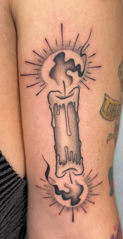 Close-up of a custom fine line double-ended candle tattoo by Raymond at Final Touch Tattoo San Antonio